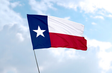 Flag of Texas in front of blue sky, realistic 3D rendering
