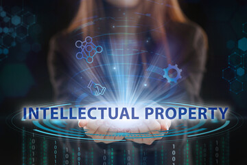 Business, Technology, Internet and network concept. Young businessman working on a virtual screen of the future and sees the inscription: Intellectual property