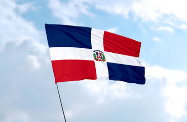 Flag of Dominican Republic, realistic 3d rendering in front of blue sky