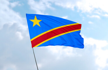 Fototapeta na wymiar Flag of DR Congo, realistic 3d rendering in front of blue sky