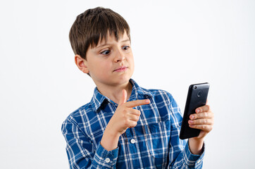 Kid looks in surprise at the smartphone