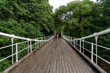 Pedestrian bridge over Akerselva River in Kuba Park in Grunerlokka quarter in Orlo. Aamodt Bru