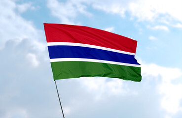 Flag of Gambia, realistic 3d rendering in front of blue sky