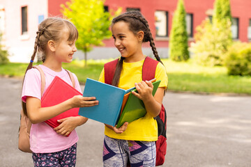 Back to school. First day of school. Two teenage girs at the school feeling happy and excited.