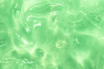 Green water Aloe Vera gel smudged texture. Abstract clear cosmetic cream, face serum, moisturizer background