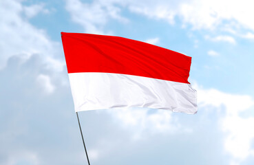Fototapeta na wymiar Flag of Indonesia, realistic 3d rendering in front of blue sky