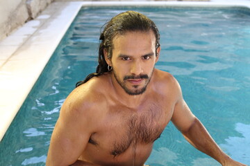 Attractive ethnic man in swimming pool 