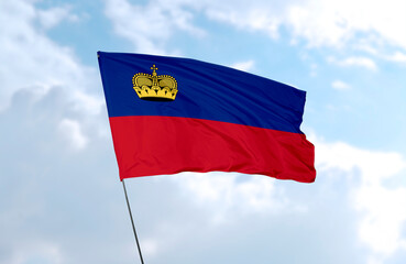 Flag of Liechtenstein, realistic 3d rendering in front of blue sky