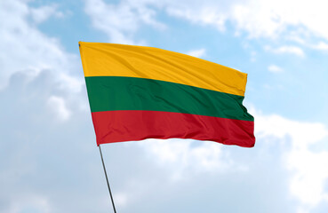 Flag of Lithuania, realistic 3d rendering in front of blue sky