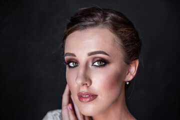 Close-up beauty portrait of young woman. Bright girl, bride with professional evening make-up.