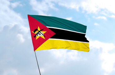 Flag of Mozambique, realistic 3d rendering in front of blue sky