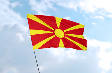 Flag of North Macedonia, realistic 3d rendering in front of blue sky