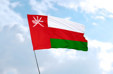 Flag of Oman, realistic 3d rendering in front of blue sky