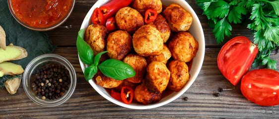 Chicken meatballs in a plate. Meatballs and basil. Copyspace. Top view. Ingredients. Wooden background