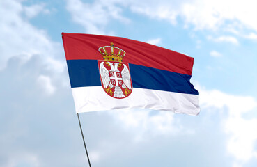 Flag of Serbia, realistic 3d rendering in front of blue sky