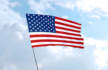 Flag of the United States of America, realistic 3d rendering in front of blue sky