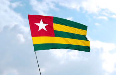 Flag of Togo, realistic 3d rendering in front of blue sky
