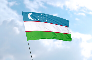 Flag of Uzbekistan, realistic 3d rendering in front of blue sky