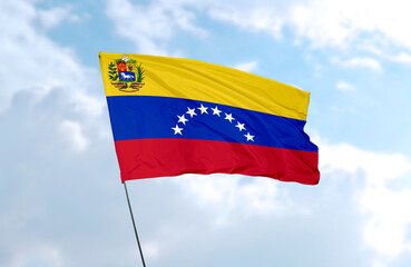 Flag of Venezuela, realistic 3d rendering in front of blue sky