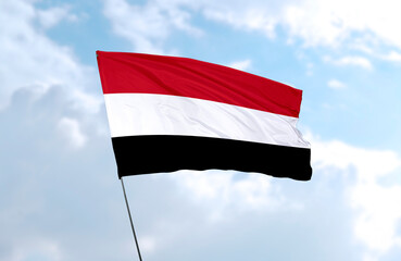 Flag of Yemen, realistic 3d rendering in front of blue sky