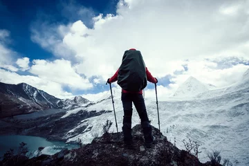 Fotobehang Successful woman backpacker hiking in winter mountains © lzf