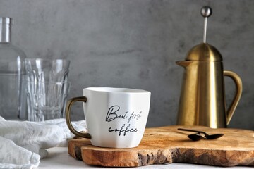Early morning coffee table with french press coffee, mug and water glasses