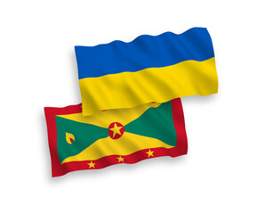 National vector fabric wave flags of Grenada and Ukraine isolated on white background. 1 to 2 proportion.