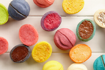 Colorful shortbread desserts on white wooden background