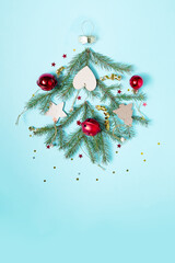 Christmas bauble made of decoration elements on blue background.