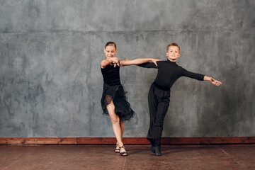 Young couple boy and girl dancing in ballroom dance Jive.