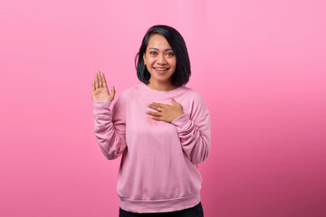 Photo of young woman happy positive smile hand on chest make promise oath tell truth isolated over pink color background