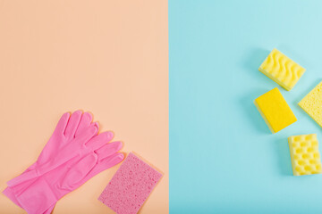 Pink and yellow cleaning set. Pink and blue background. Cleaning concept. Creative flat lay, top view