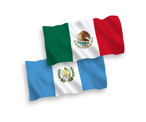 National vector fabric wave flags of Mexico and Republic of Guatemala isolated on white background. 1 to 2 proportion.