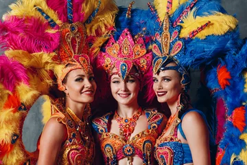 Fotobehang Three Woman in brazilian samba carnival costume with colorful feathers plumage. © primipil