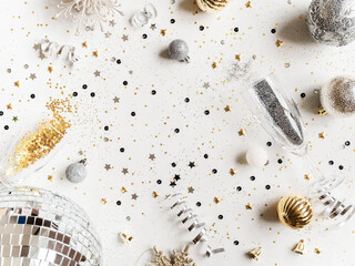 Flat lay of Christmas or New Year, gold and silver party season decorations on white background.