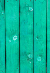 Fototapeta premium Green planks of the village fence. Vertical background