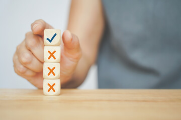 senior business woman selected correct icon on wooden cube from her experience for business, make a...