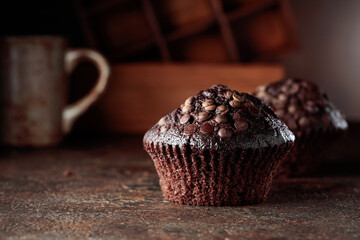 Chocolate muffins on a brown background.