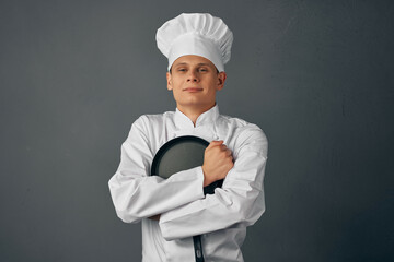 chef hugs frying pan kitchen professional dark background