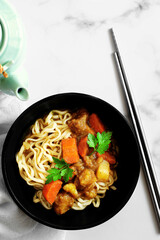 Curry ramen with vegetables. White background