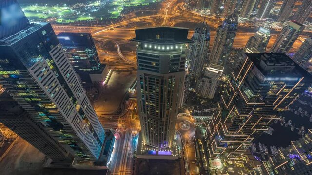 Look down aerial view of a road intersections between skyscrapers in a big city timelapse.