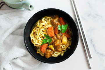 Curry ramen with vegetables. White background