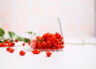 Fresh Goji berries in transparent glass. Healthy antiage superfood.