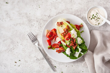 romaine lettuce topped with bacon tomato parmesan, sauce. healthy keto paleo diet lunch