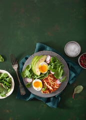 healthy keto paleo diet breakfast: boiled egg, avocado, halloumi cheese, salad leaves