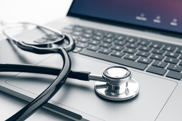 Stethoscope on modern laptop computer. Online health care or telemedicine concept