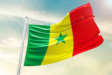 Senegal national flag waving in beautiful clouds.