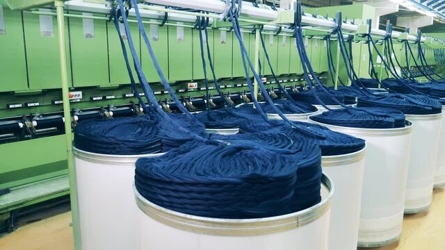 Textile rolling machine is unwinding hasps of yarn