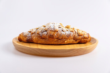 Delicious croissants and coffee cup on wooden plate. Freshly baked.
