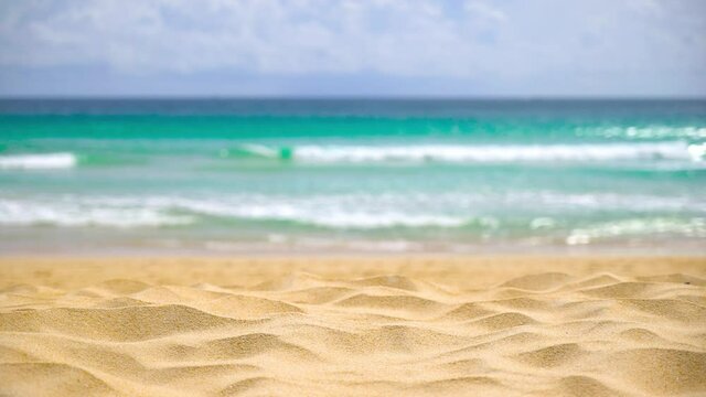Fine beach sand in summer sun sea motion blur background.